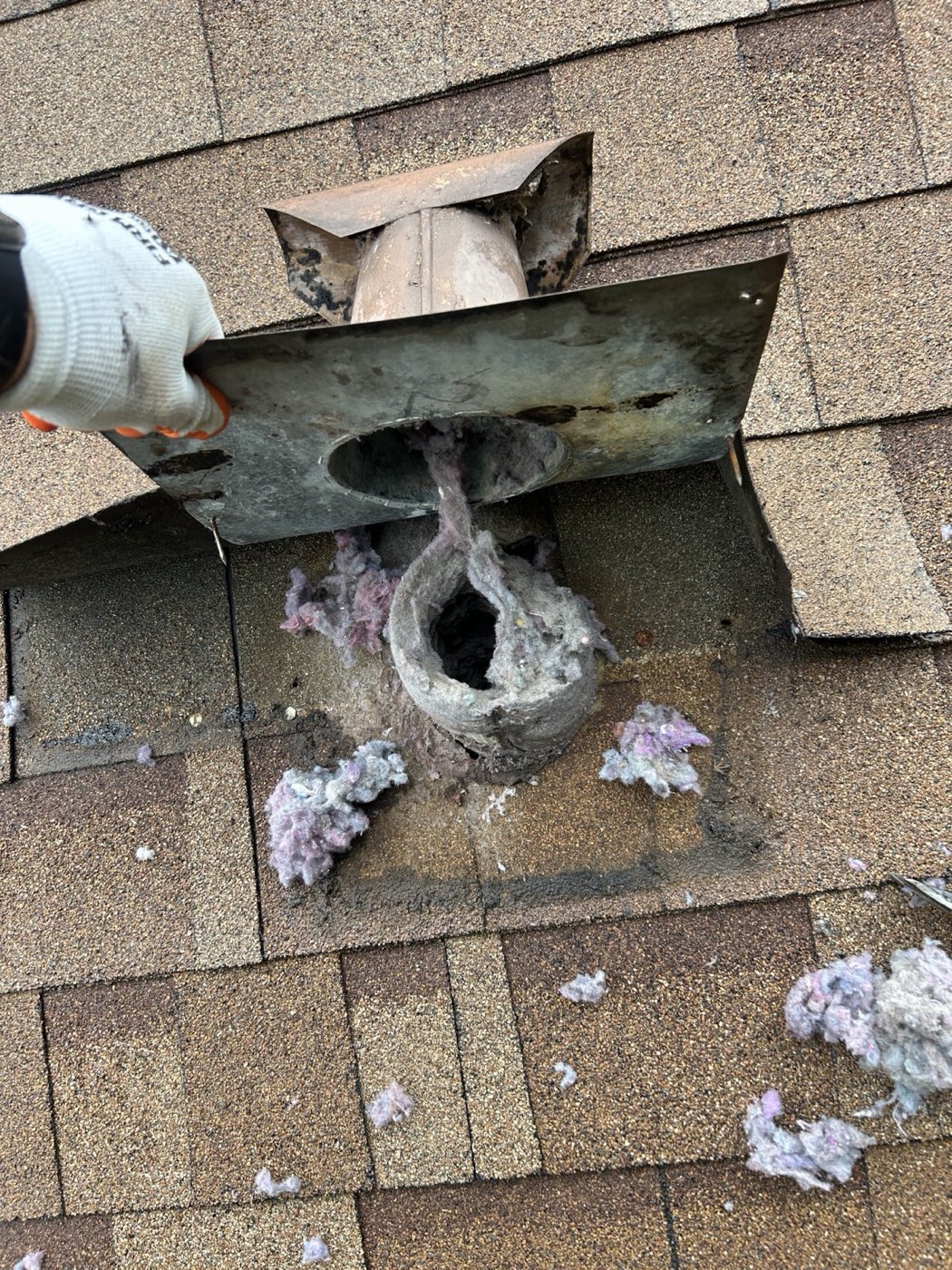 Roof vent cap removed, duct packed solid with lint before cleaning
